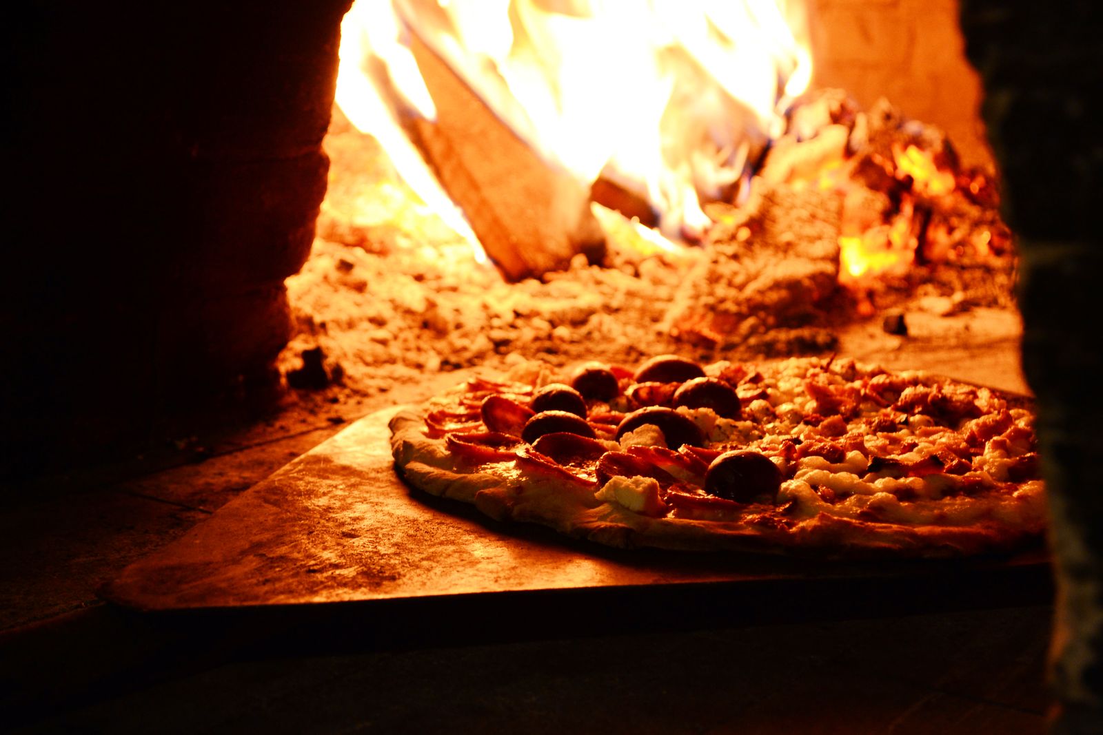 Pizza on the peel by the fire