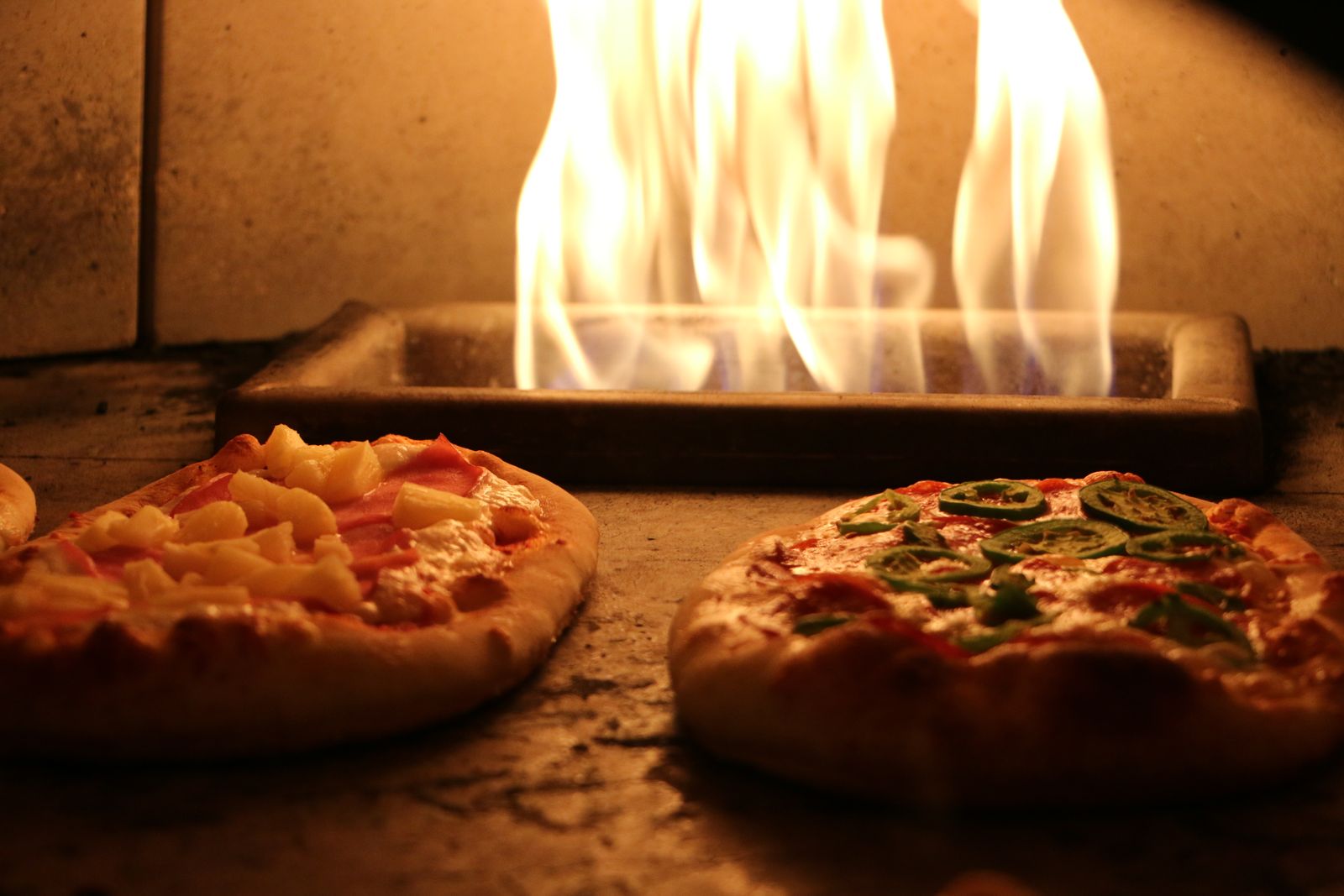 Pizzas baking in the wood-fired oven