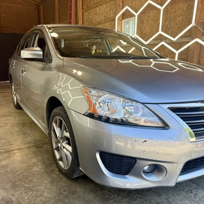 Silver Nissan Sentra detailed in the barn