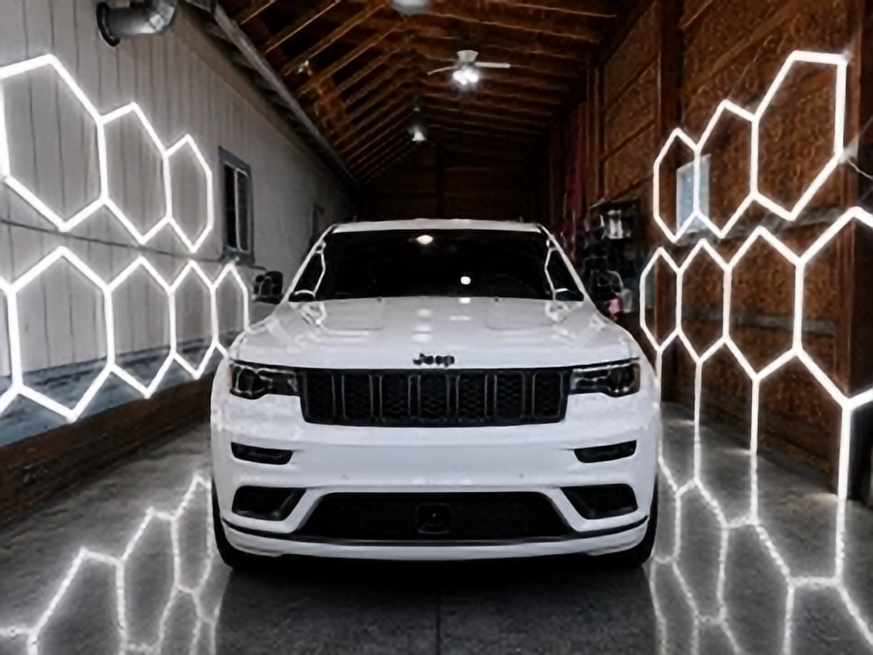 The detailing barn lit with hexagon LED lights and a vehicle inside