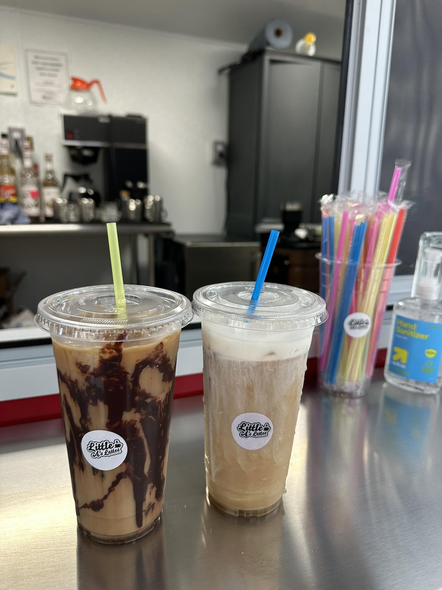 An iced mocha with chocolate swirl beside an iced latte on the trailer counter