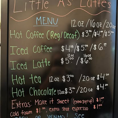 Little A's Lattes hand-written chalkboard menu listing coffees, iced lattes and prices