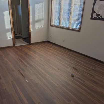Finished room with new luxury-vinyl plank flooring by S&T Home Improvements