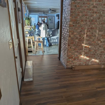 Open layout with brick column and new flooring