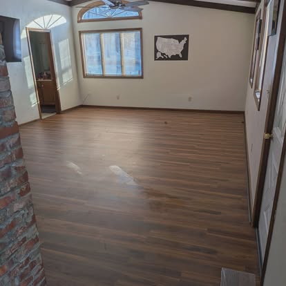 Bright finished room with dark flooring