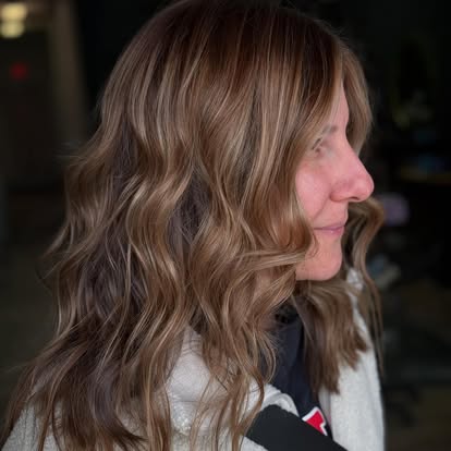 Caramel balayage with beach waves, side profile